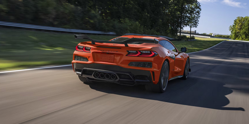 Rear view of an orange 2026 Chevrolet Corvette Z06, showcasing its sleek design and distinctive taillights.